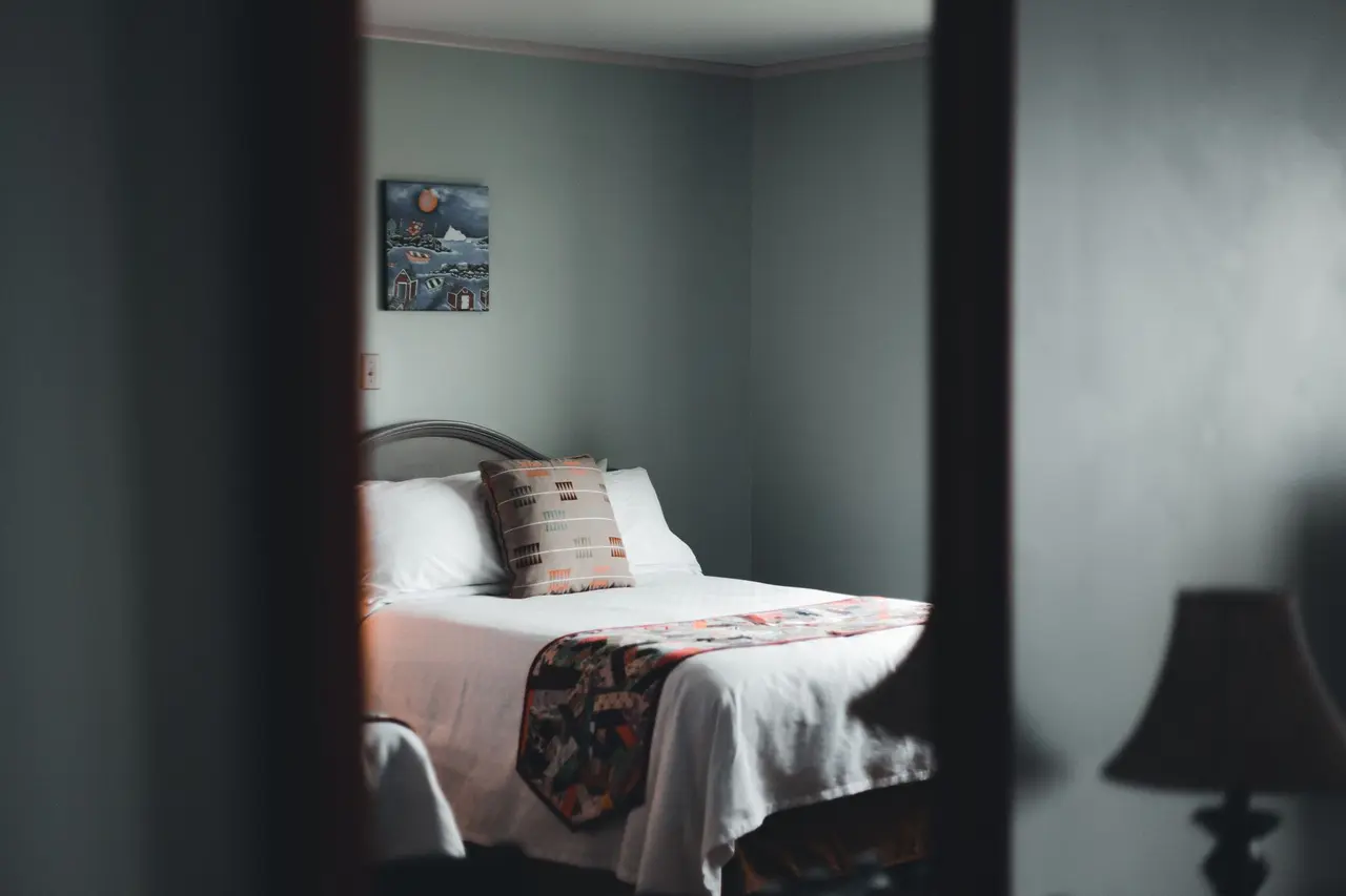 Soft white bedding in a quiet room